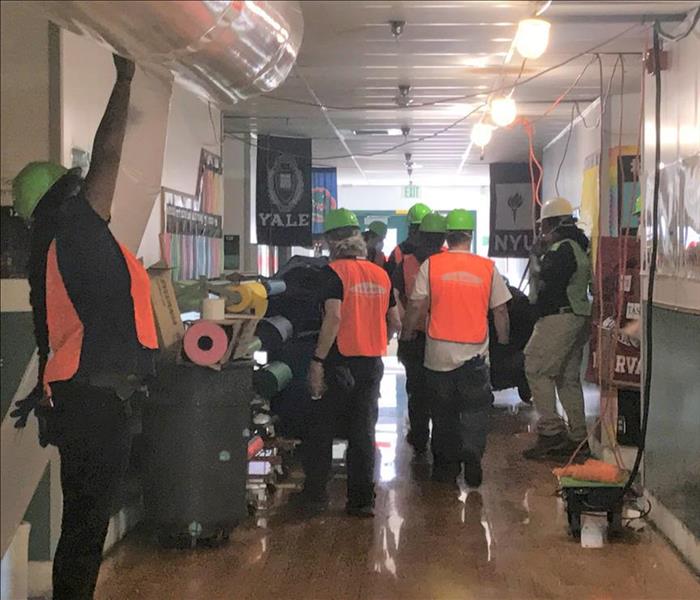 A group of workers getting ready to clean a building after flood damage in Puyallup, WA